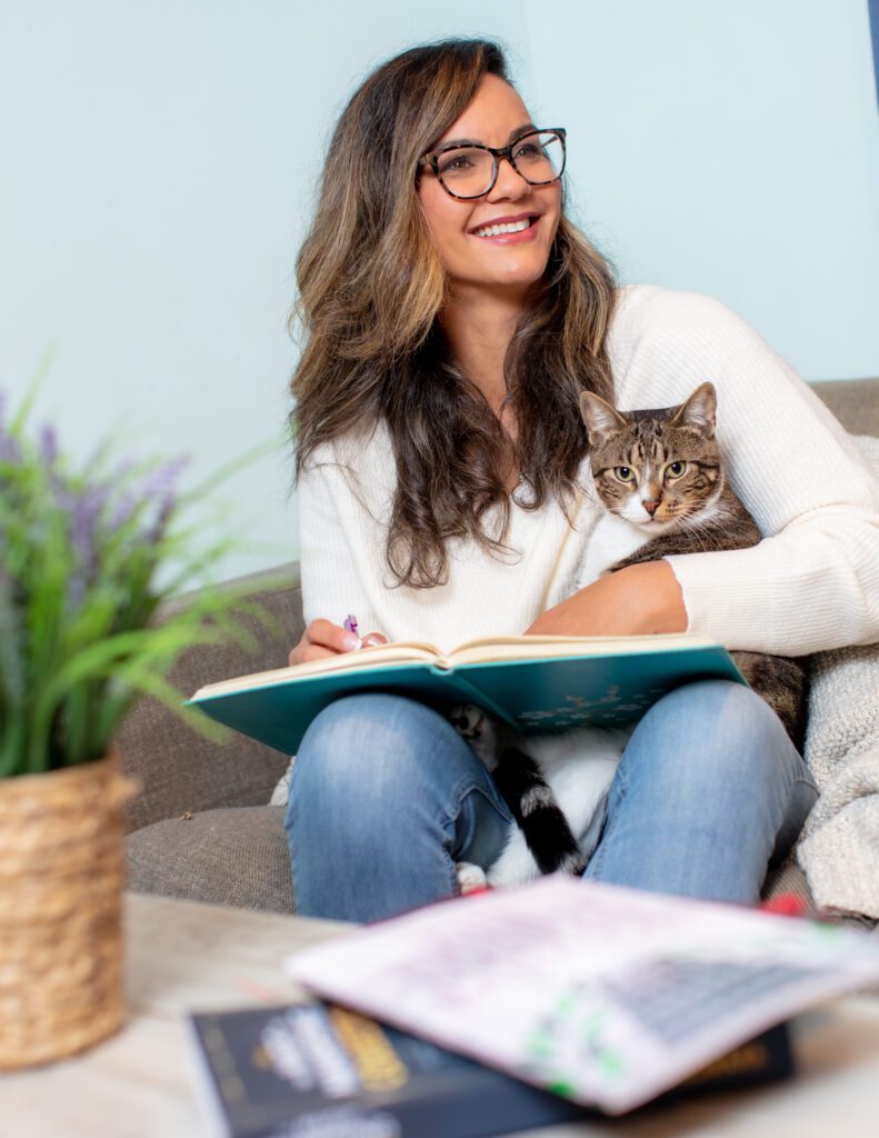 Rebeca Elizabeth reading with her cat — entrepreneur and business systems strategist teaching calm leadership and work life balance for entrepreneurs